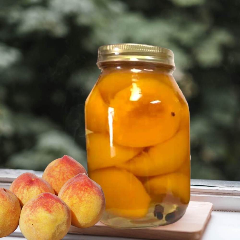 Jar of preserved peaches on a windowsill with fresh peaches beside it.
