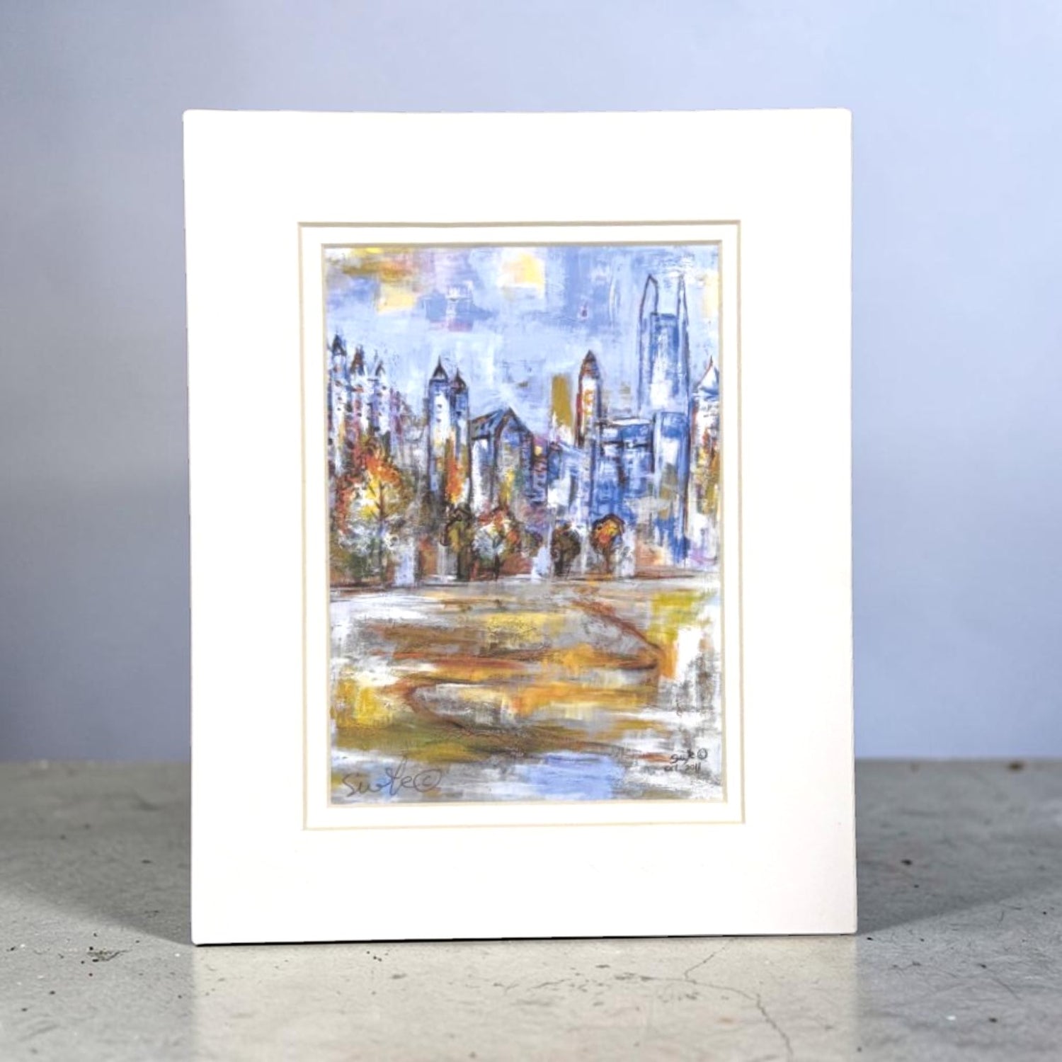 Framed abstract Atlanta cityscape painting on a plain background