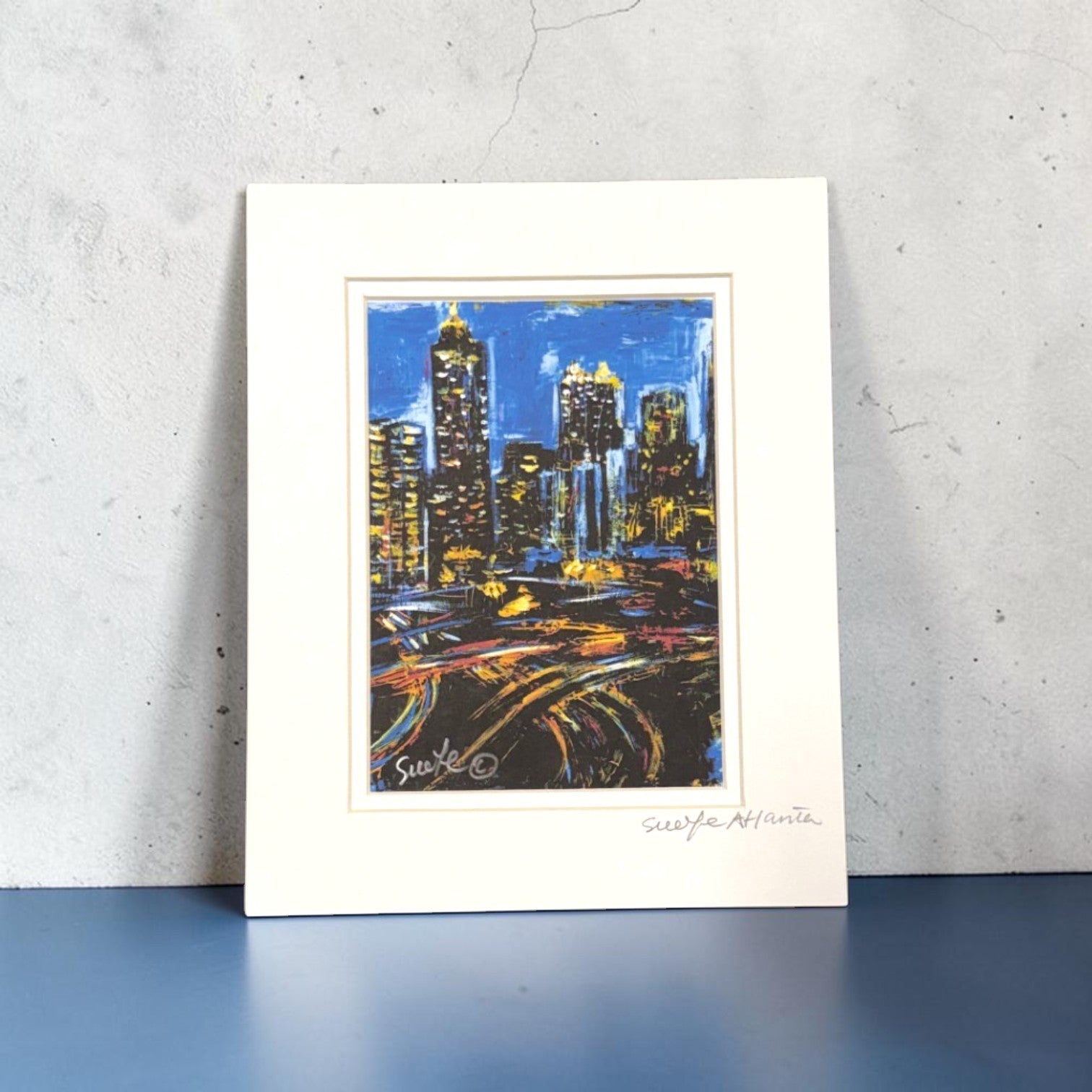 Framed artwork of the Atlanta skyline cityscape at night on a textured surface