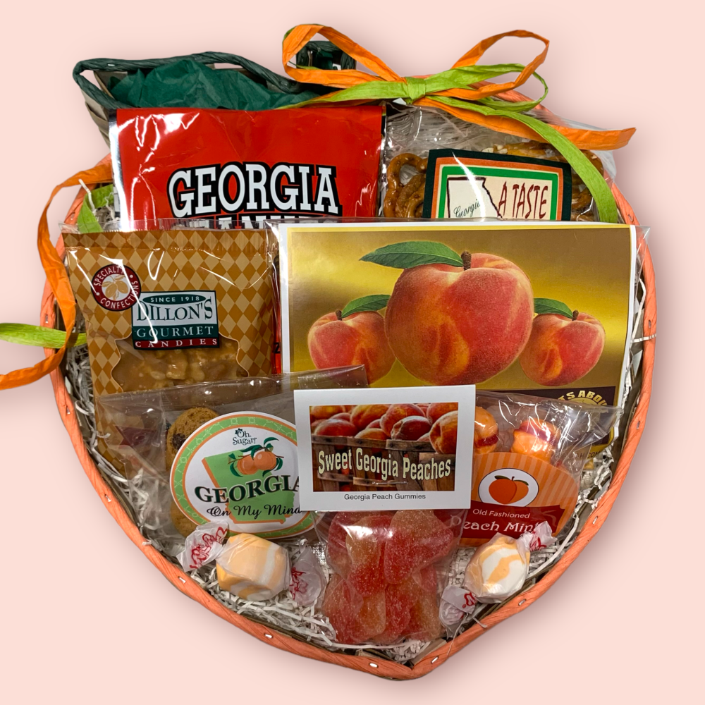 Peach shaped wicker basket filled with peach popcorn, peach candy, cookies, pralines and assorted Georgia snacks make up this Georgia Peach Gift