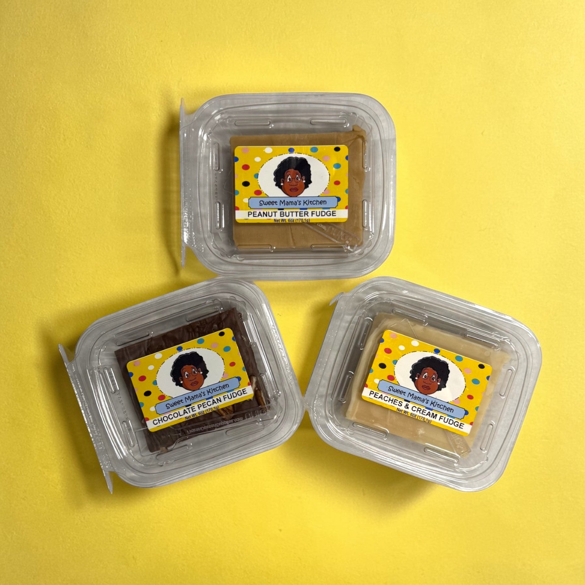 Three containers of fudge in assorted flavors with labels on a yellow background