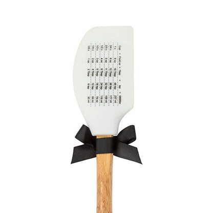 Back view of a Georgia white spatula with wooden handle, black ribbon and cooking measurements on a white background