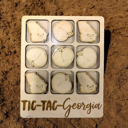 Wooden tic-tac-toe game for Georgia with laser cut peaches and state of Georgia marker pieces