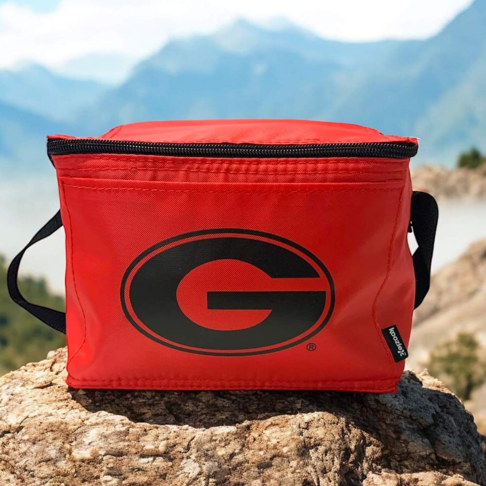 Red cooler bag with University of Georgia logo on the front against an outdoor landscape