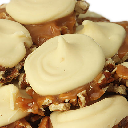 Close-up of white chocolate gopher turtles from Savannah Candy Kitchen with caramel and pecans.