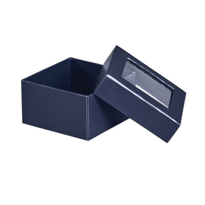 A dark navy blue square gift box with its lid propped open, featuring a clear plastic window on the lid, set against a plain white background.