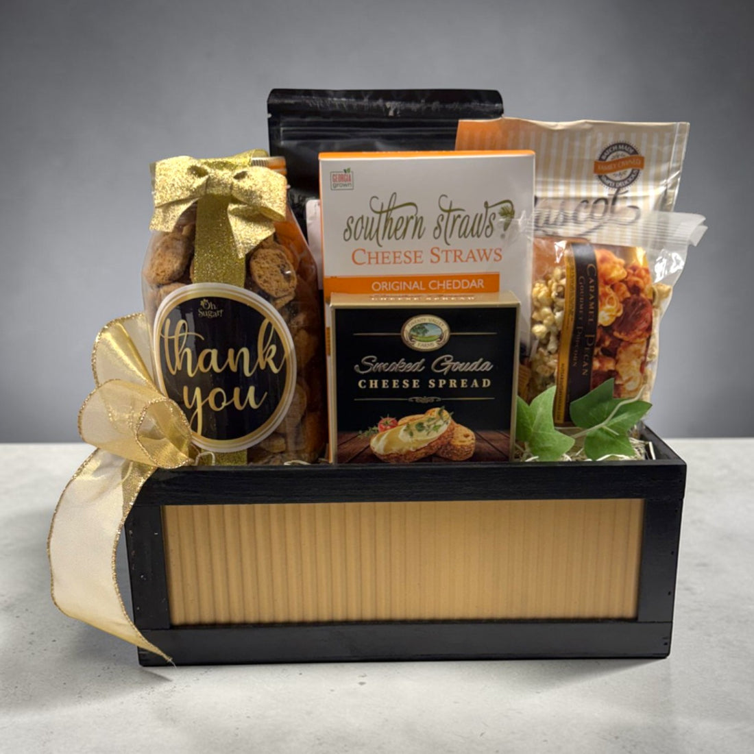 Gift basket with cheese straws, cheese spread, and a &