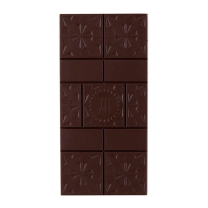 Dark chocolate bar with embossed design on a white background