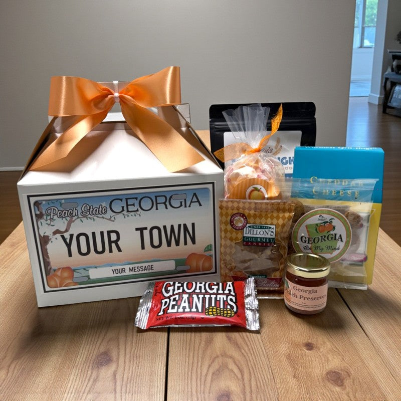 Personalized gift box with Georgia-themed products on a wooden surface